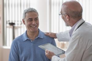 Man seeing urologist in doctor office