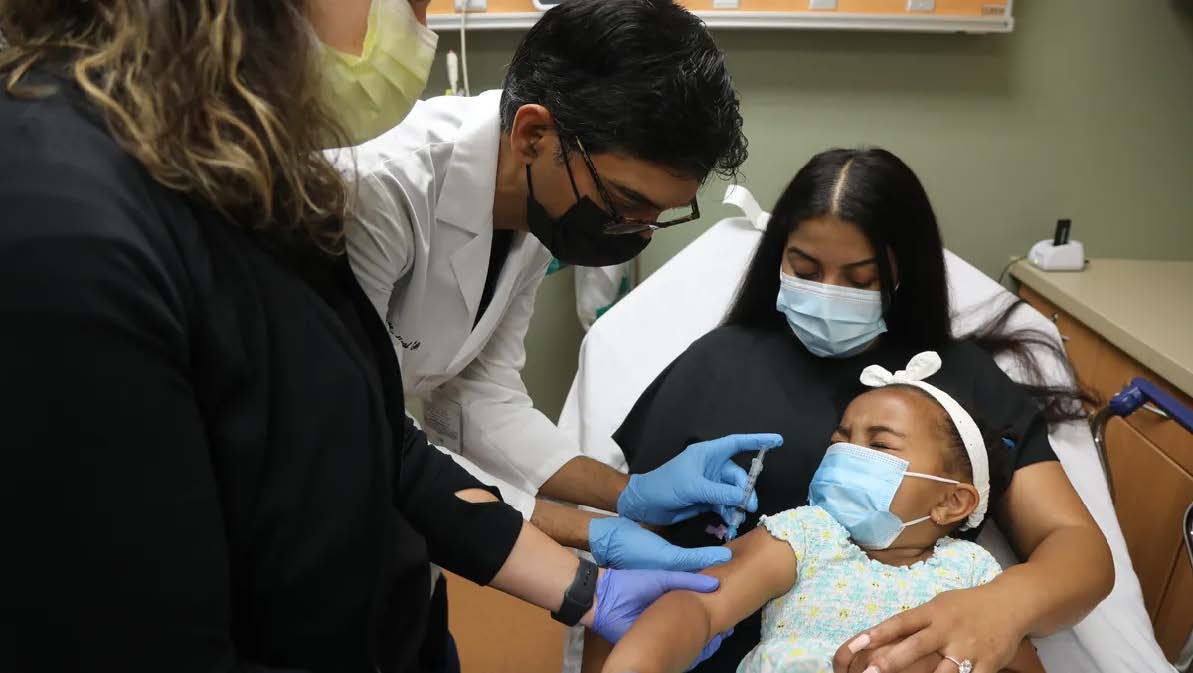 New Jersey doctor administering monkeypox vaccine to a young girl