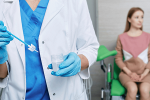 Woman sitting and waiting to get a Pap Smear at her doctor’s office.  Meta Description: Learn how often you should get a Pap Smear and why you need one. 